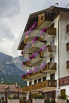 Cityscape of FaÃ§ade and flowers on balconies, in Cortina dAmpezzo, Province of Belluno, Italy photo