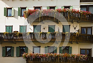 Cityscape of façade and flowers on balconies, in Cortina dAmpezzo, Province of Belluno, Italy