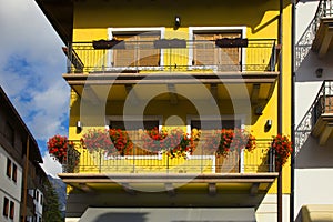Cityscape of Façade and flowers on balconies, in Cortina dAmpezzo, Province of Belluno, Italy