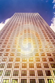 Cityscape featuring modern office exterior from a low angle at sunset