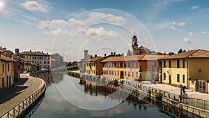 Cityscape of Gaggiano, just outside of Milan. Colourful houses reflected in the Naviglio Grande canal waterway and