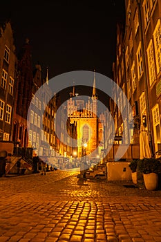 Cityscape of Gdansk with St. Mary Basilica and City Hall at night, Poland. Beautiful architecture of Mariacka street