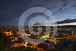 Cityscape of Graz with Mariahilfer church and historic buildings, in Graz, Styria region, Austria, by night