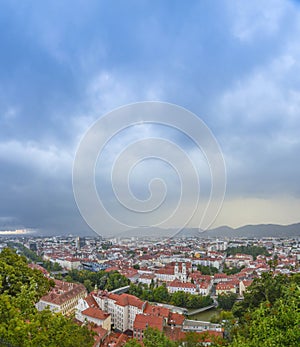 Cityscape of Graz with Mariahilfer church and historic and modern buildings of Graz, Styria region, Austria, at sunset. Dramatic