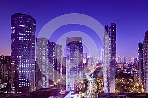 Cityscape with hectic traffic and skyscrapers at dusk,view in the business district. photo