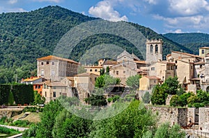 Cityscape of the historic Catalan city of Besalu, mountains in the background