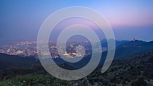 Cityscape of Hong Kong as viewed atop Kowloon Peak with day to night timelapse with Hong kong and Kowloon below