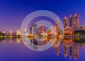 Cityscape image of Benchakitti Park at twilight time in Bangkok, Thailand.