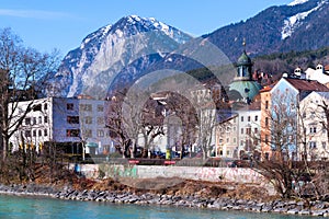 Cityscape of Innsbruck city center with beautiful houses, river Inn and Tyrolean Alps, Austria, Europe