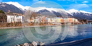 Cityscape of Innsbruck city center with beautiful houses, river Inn and Tyrolian Alps, Austria, Europe