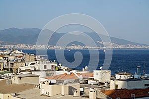 Cityscape of Izmir with residential buildings by a beautiful sea in Alsancak quarter photo