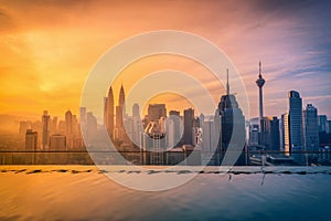 Cityscape of Kuala lumpur city skyline with swimming pool on the