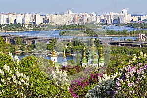 Cityscape of Kyiv with lilac blossom in spring