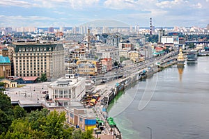 Cityscape of Kyiv, view of the river station on the Dnipro River and the embankment in the old district of Podil. 07.24.22. Kyiv.