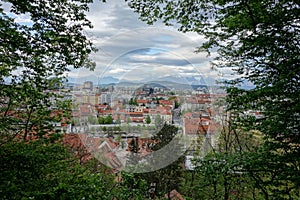 Cityscape of Ljubljana, capital city of Slovenia,viewed from Castle hill through the outlook between trees