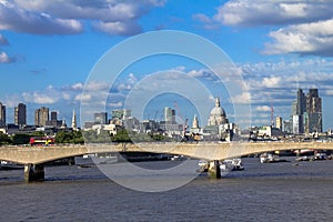 Cityscape of London in late afternoon light from Hungerford Bridge.