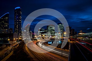 Cityscape of London at night in Canary Wharf, The cityâ€™s second largest financial center, with light trails on the freeway