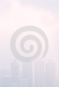 Cityscape in the mist, tall building in thick mist, uncleared or blurred image view, vertical image with blank space area for copy