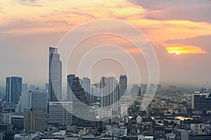 Cityscape of modern buildings and urban architecture. Aerial view of Bangkok city at twilight sunset in Thailand