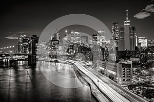 Cityscape at night of Lower Manhattan Financial District with illuminated skyscrapers. New York City Black & White