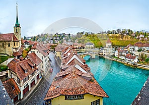 The cityscape of the oldest part of Bern with outstanding townhouses, Nydegg church and bridge across Aare river, Switzerland