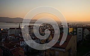 Cityscape panorama sunset skyline of colorful houses buildings urban architecture in Santander Cantabria Spain Europe photo