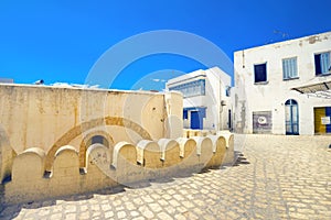 Cityscape with part of fortress wall and narrow street in Sousse. Tunisia, North Africa