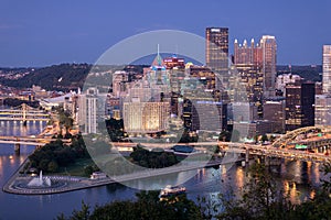 Cityscape of Pittsburgh and Evening Light. Fort Pitt Bridge. Blurry Ferry Cruise in Background Because of Long Exposure. Selective