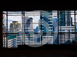 Cityscape reflected on glassy building, The structure of the building`s view of the city from the office windows
