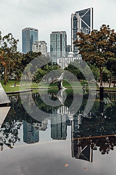 Cityscape that reflected on the pool near Petronas twin towers park`s pool in Kuala Lumpur, Malaysia