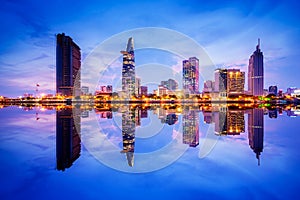 Cityscape in reflection of Ho Chi Minh city at beautiful twilight, viewed over Saigon river.