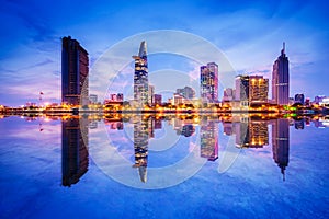 Cityscape in reflection of Ho Chi Minh city at beautiful twilight, viewed over Saigon river.