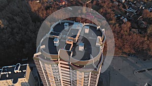 Cityscape. Residential complex on the river bank. Aerial footage from a copter at sunset time