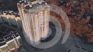 Cityscape. Residential complex on the river bank. Aerial footage from a copter at sunset time