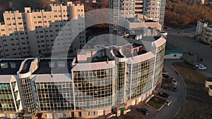 Cityscape. Residential complex on the river bank. Aerial footage from a copter at sunset time