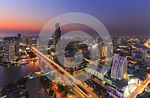 Cityscape of River in Bangkok city with high office building in night time