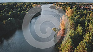 Cityscape at river bank aerial. Green autumn nobody nature landscape. Leafy trees forest. Cottages