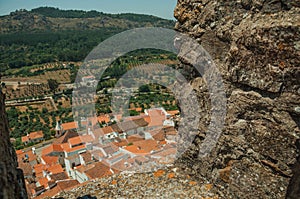 Cityscape with roofs seen by crenel in the castle wall