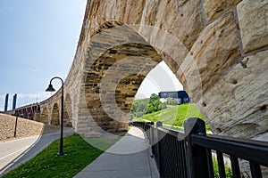 Cityscape scene of downtown Minneapolis, as seen from Mill Ruins Park. View of the Stone Arch bridge on sunny spring day