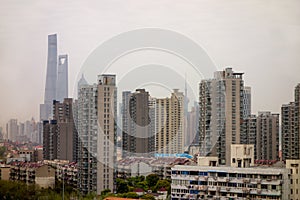 Cityscape of Shanghai, China with a lot of houses covered in a smog