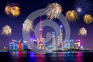 Cityscape of Shanghai at twilight sunset with fireworks. Panoramic view of Pudong business district skyline from the Bund during