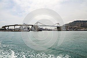 Cityscape skyline of bascule Europa Bridge across harbor in Barcelona