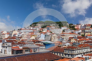 Cityscape and skyline of Lisbon, Portugal. Castelo de Sao Jorge Castle aka Saint or St George Castle, with rooftops of Baixa,