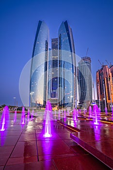 Cityscape with skyscrapers of Abu Dhabi at night, capital of United Arab Emirates