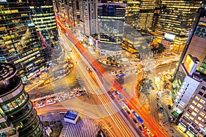 Cityscape of South Korea. Night traffic speeds through an intersection in the Gangnam district of Seoul, Korea.