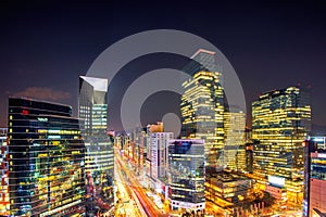 Cityscape of South Korea. Night traffic speeds through an intersection in the Gangnam district of Seoul, Korea.