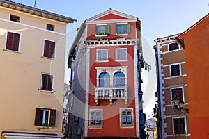 cityscape street view in Rovinj Croatia with yellow and red houses doors and shutters