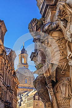 Cityscape - street view with sculpture of gatekeeper against the backdrop of the Dresden Frauenkirche