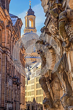 Cityscape - street view with sculptures of gatekeepers on the George Gate of Dresden Castle against the backdrop of the Dresden Fr