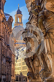 Cityscape - street view with sculptures of gatekeepers on the George Gate of Dresden Castle against the backdrop of the Frauenkirc